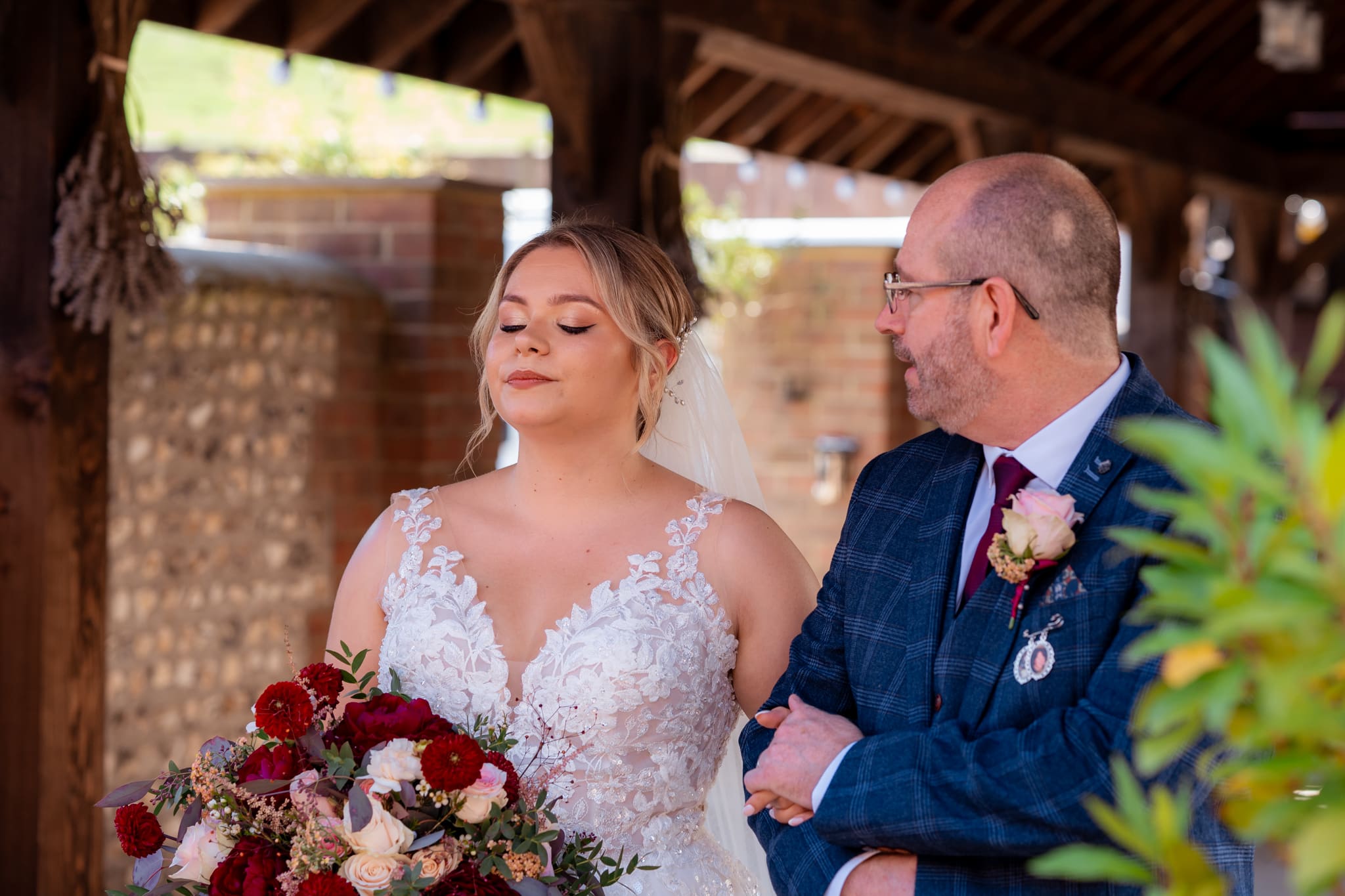 Bride taking a deep breath before walking down the aisle at Long Furlong Barn during her West Sussex barn wedding.