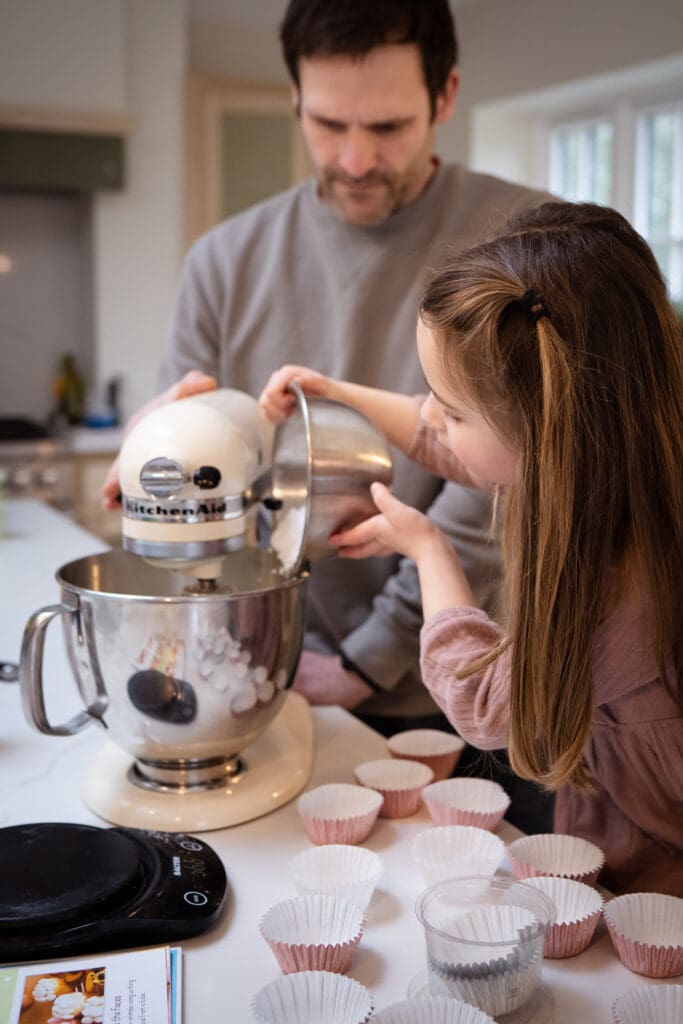Father and daughter baking at home during Sussex family photoshoot
