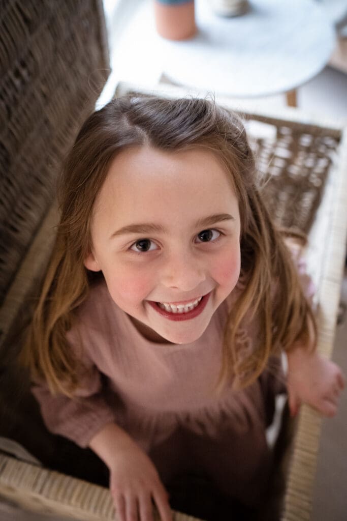 Girl smiling naturally during at-home Sussex family photoshoot