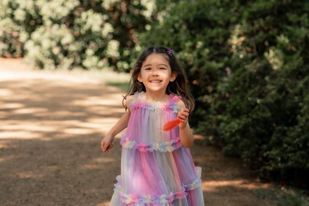 Playful sibling enjoying nature during a relaxed Sussex photoshoot.