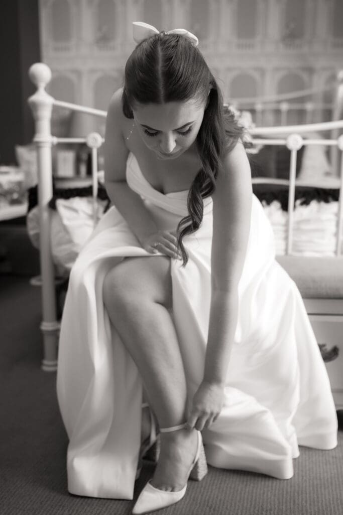 Bride putting on wedding shoes during bridal preparations | documentary wedding photography Sussex