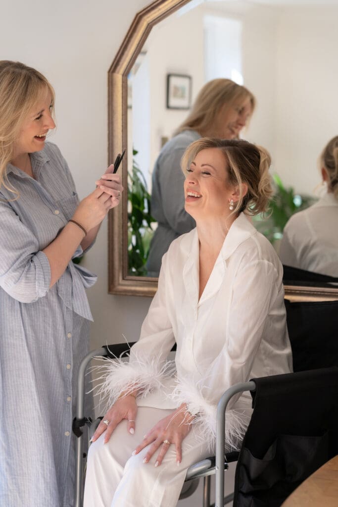 Rachel Caws bridal hair artist and model laughing together during lifestyle branding shoot in Sussex