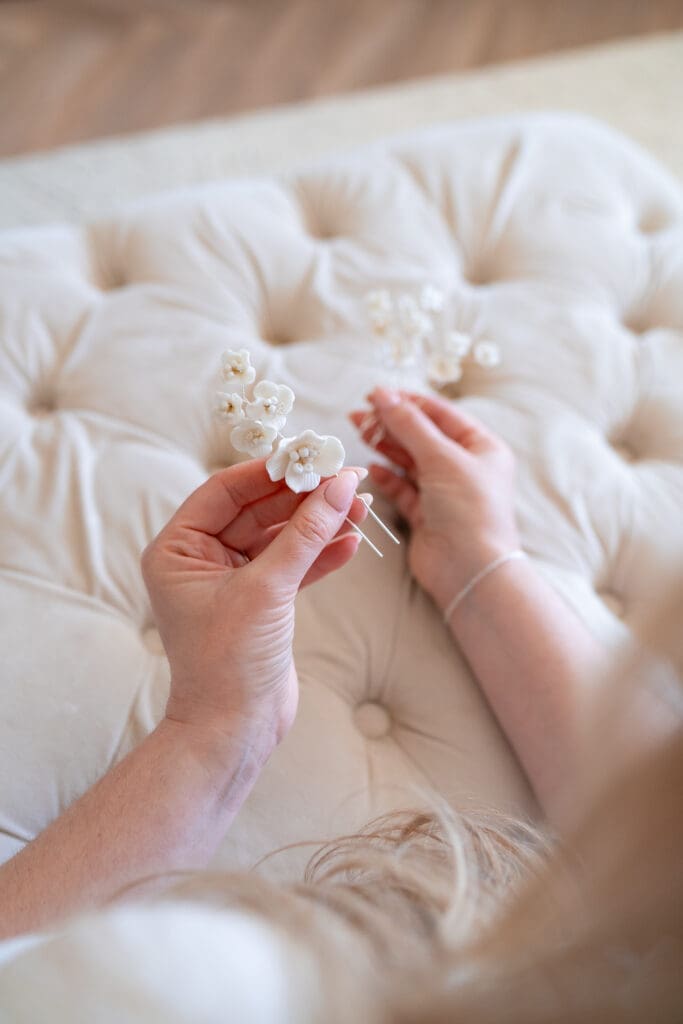 Bridal hair accessories held by hair and makeup artist during branding shoot in Sussex