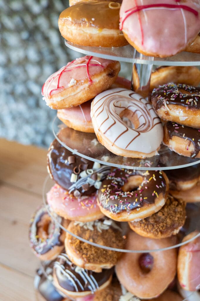 Tower of iced doughnuts served instead of a wedding cake